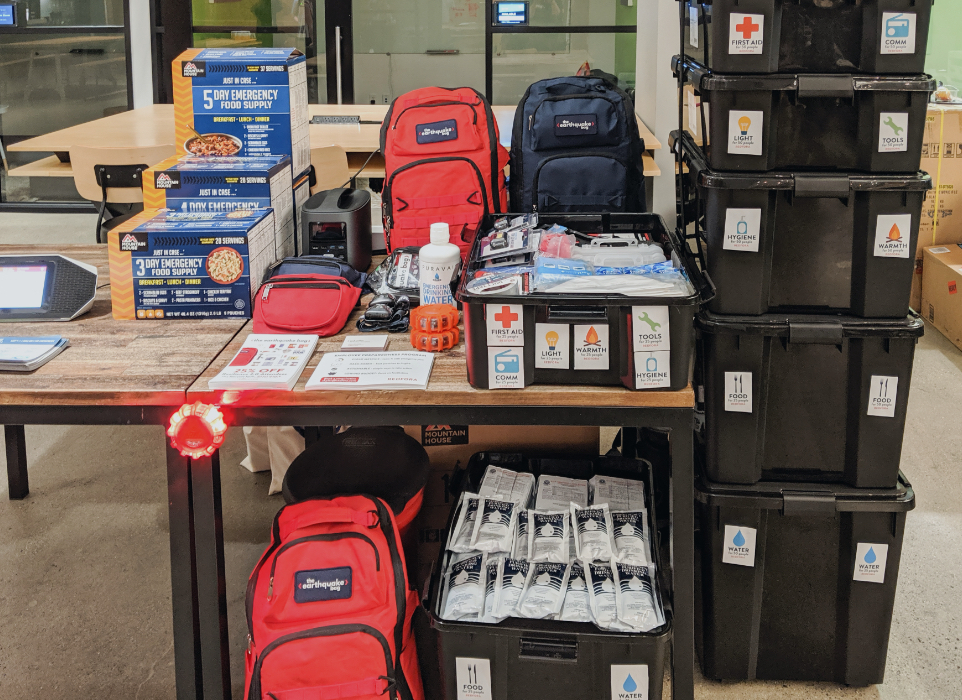 Wooden table with various types of medical and evacuation supplies on it. 