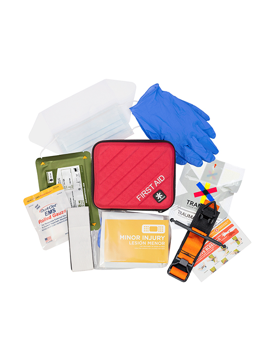 Medical supplies from a first aid kit spread out flat surface.